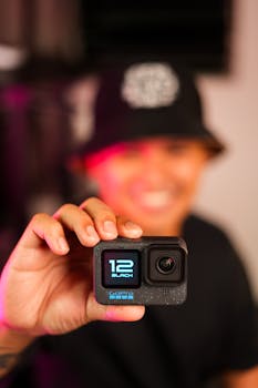 Person holding a GoPro HERO12 Black camera with a blurred background for creative focus.