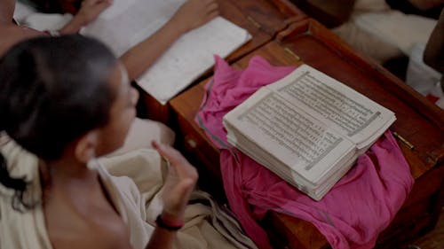 Person Praying above a Book