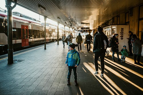 A child standing in front of a train station