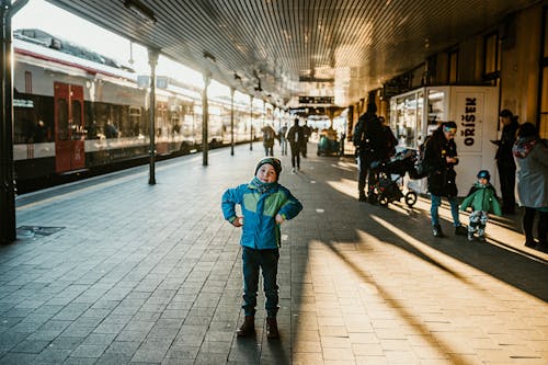 A child standing on a train platform