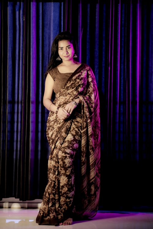 A beautiful woman in a brown sari