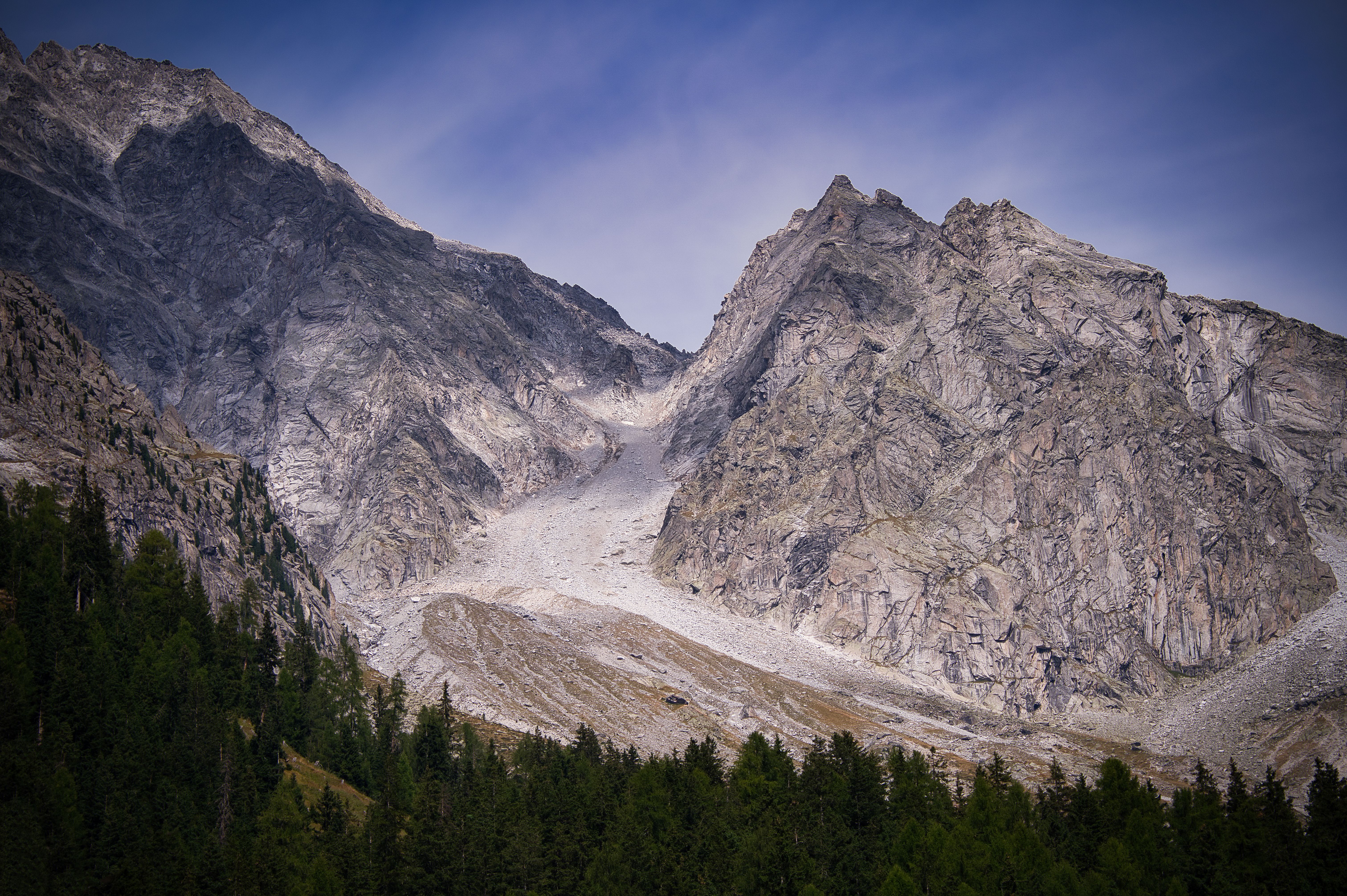 Large Mountain Slope without Snow next to a Forest · Free Stock Photo