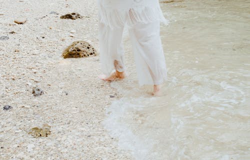 Person in White Pants in Beach