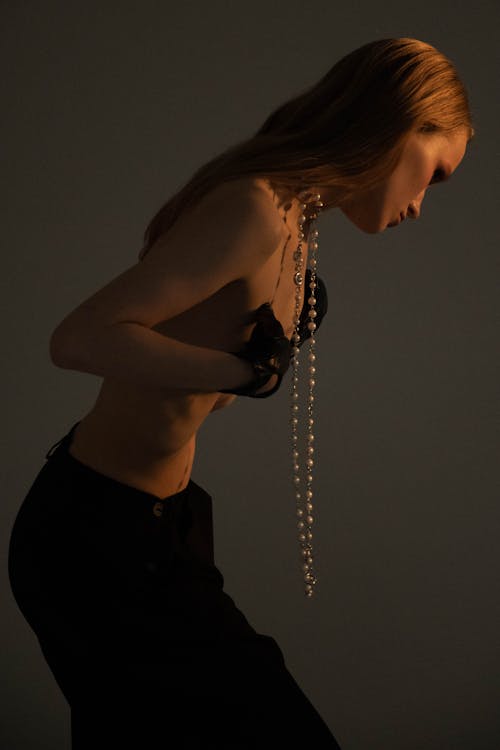 Topless Woman with a String of Pearls on her Neck 