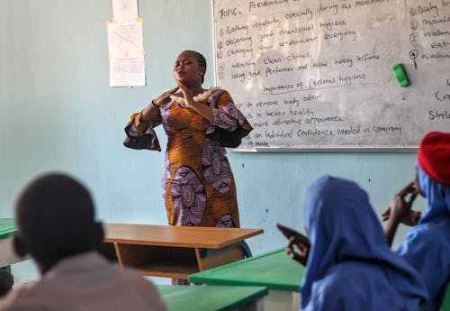 Free A woman teaching in a classroom with children Stock Photo