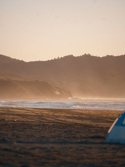 A tent on the beach at sunset