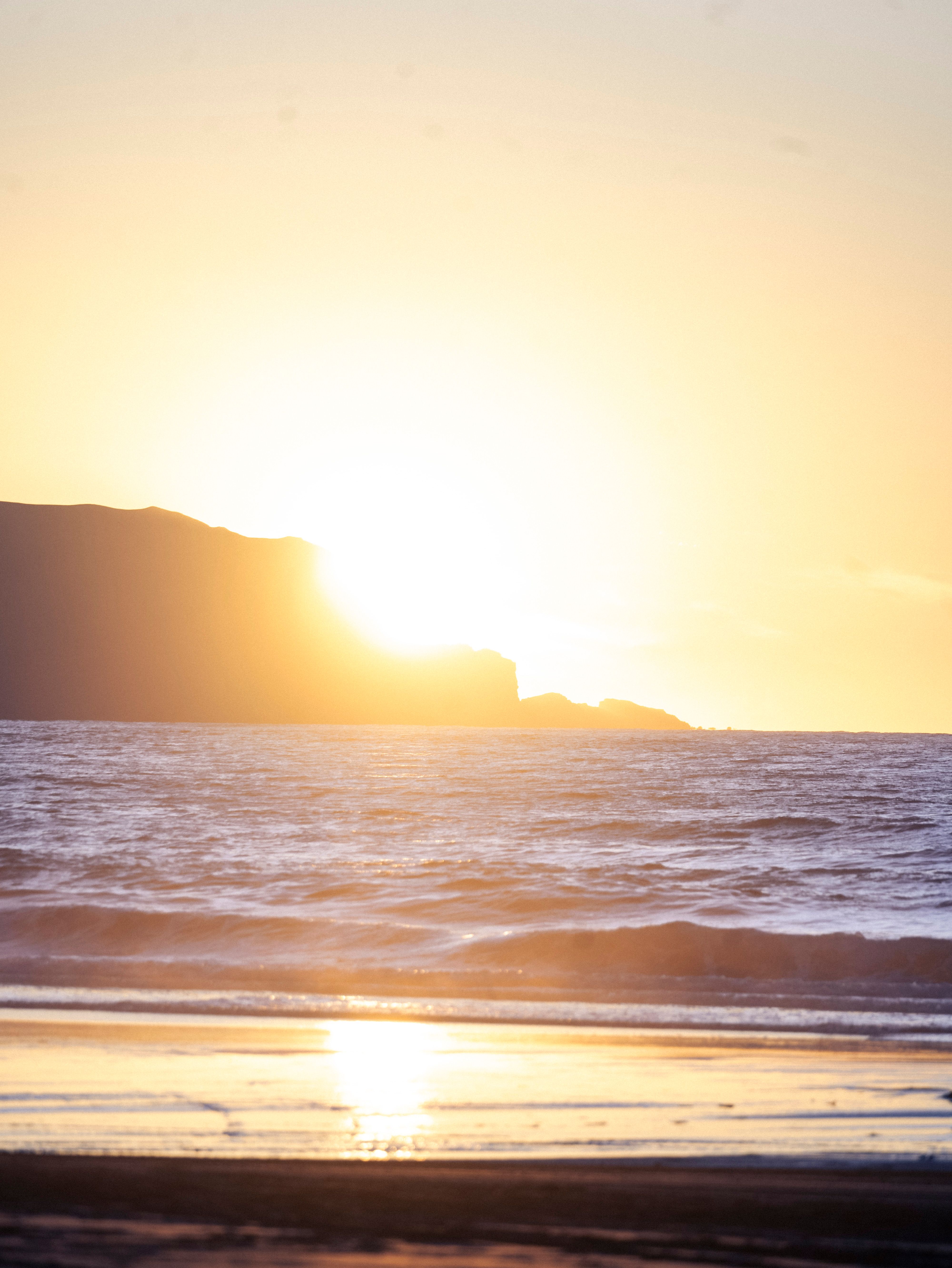 Sun on Yellow Sky over Sea Coast at Sunset · Free Stock Photo