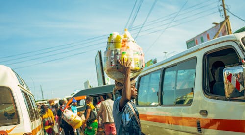 A man carrying a large load of water on his head
