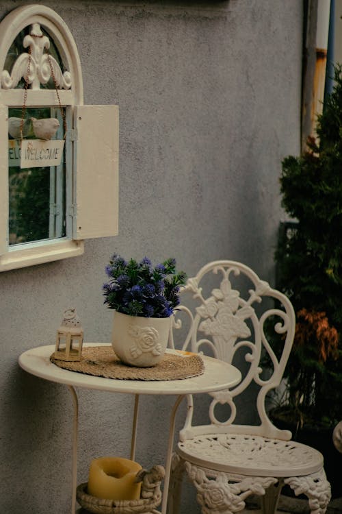 A Table and Chair Standing Outside of a Cafe