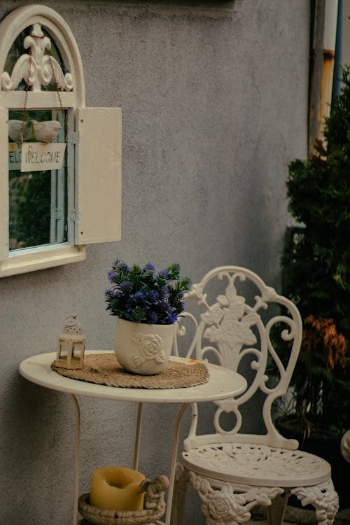 A white table with a vase of flowers on it