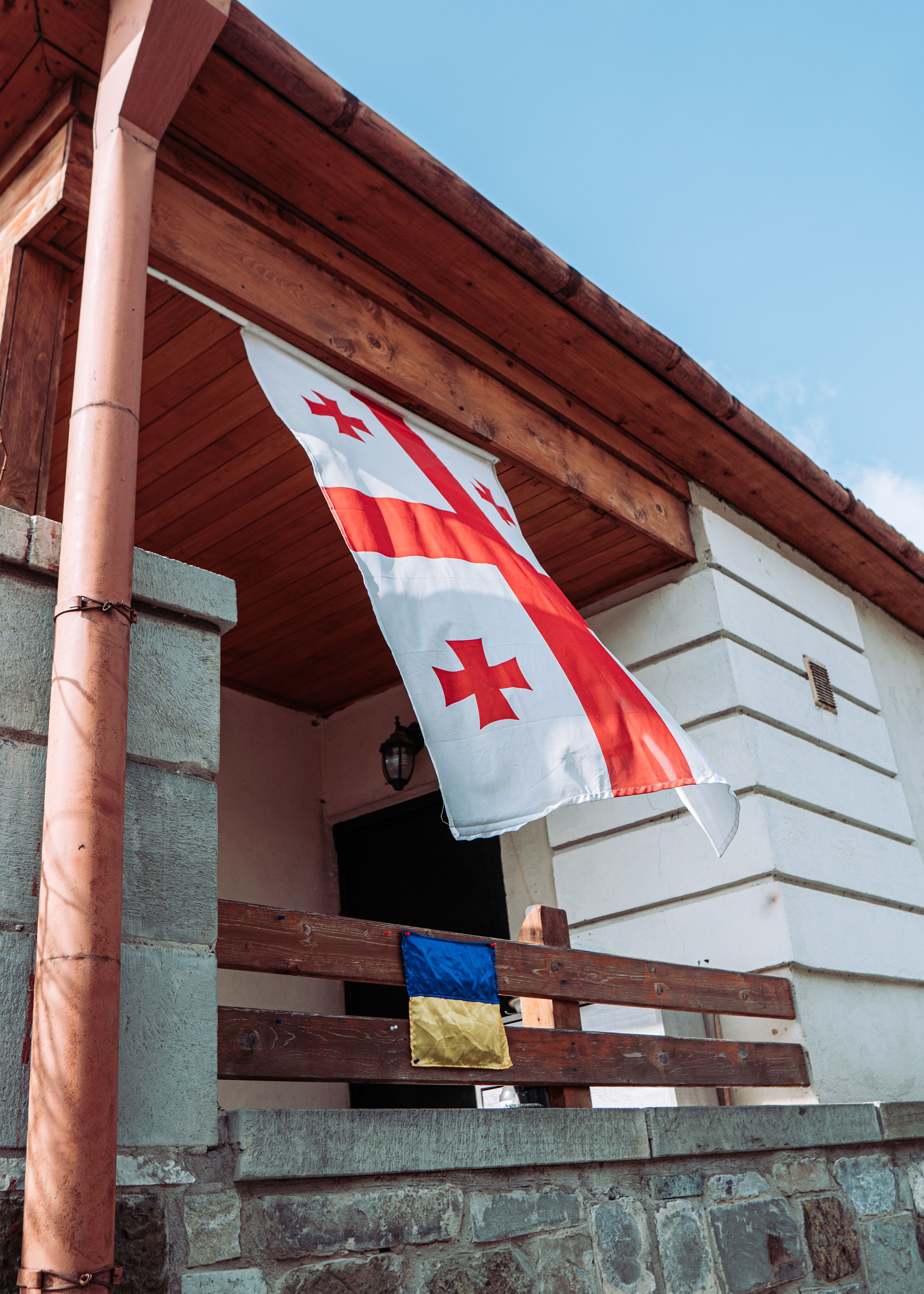 Flags of Georgia and Ukraine on House Porch · Free Stock Photo
