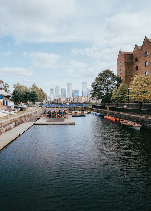 A canal with boats and buildings in the background