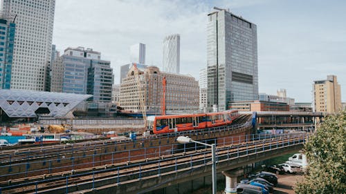 A train traveling through a city with tall buildings