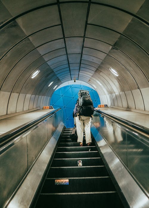 A person walking down an escalator in a subway