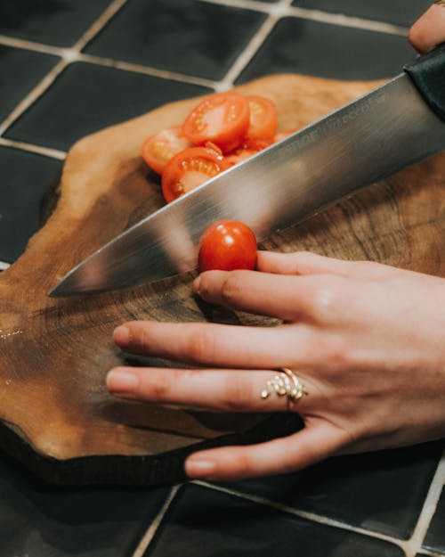 Woman Hand Cutting Tomatoes