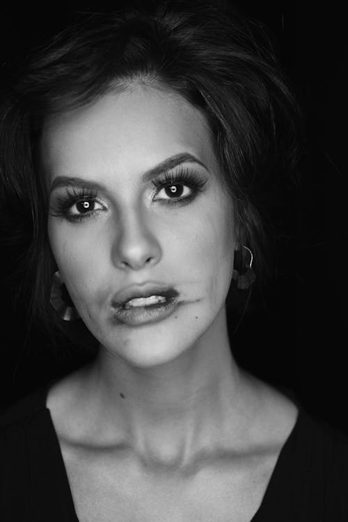 A black and white photo of a woman with makeup