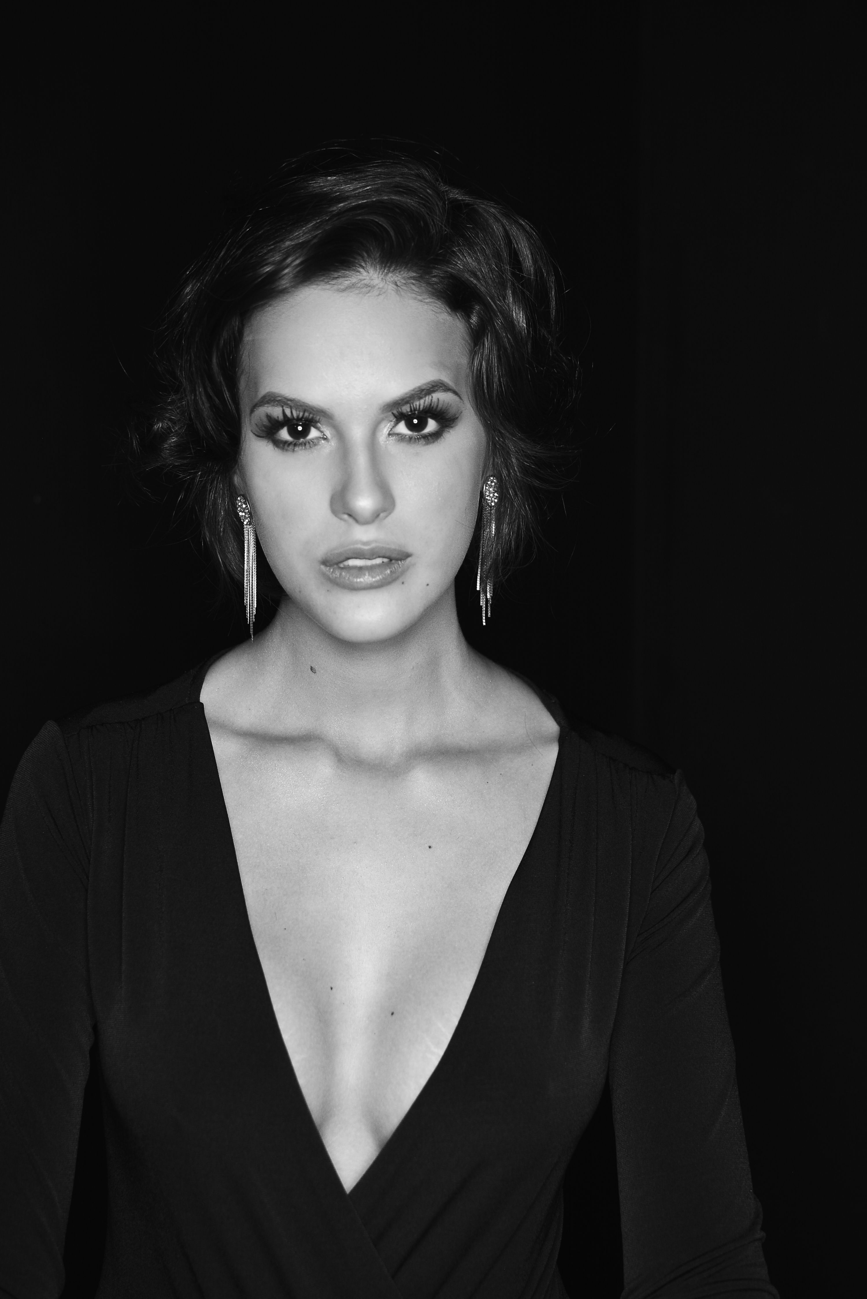 Stunning black and white portrait of a woman in evening attire, showcasing elegance.