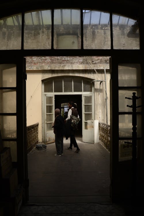 Woman and Man Walking in Vintage Building