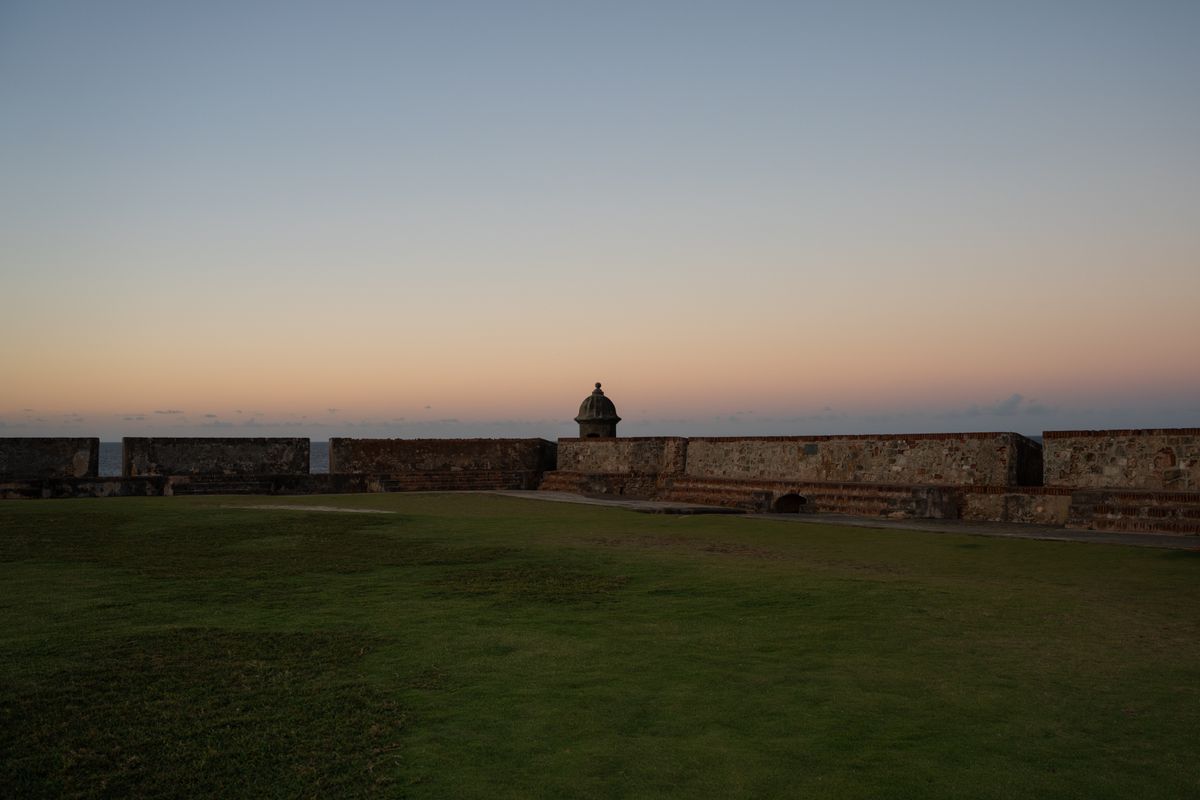 Peaceful sunset view of a historic fort in San Juan, Puerto Rico with clear skie