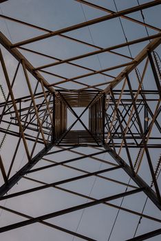 Symmetrical view from below of a steel tower against clear sky, showcasing engineering marvel.