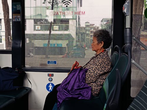 Elderly Woman Commuting by Bus