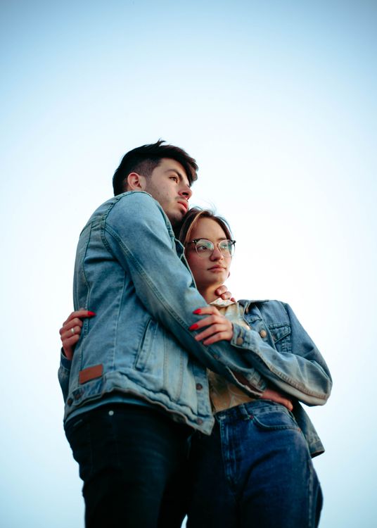 Hugging Jacket Hugging Couple in Denim Jackets · Free Stock Photo
