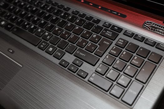High-angle view of a laptop keyboard featuring a numeric keypad and sleek design.