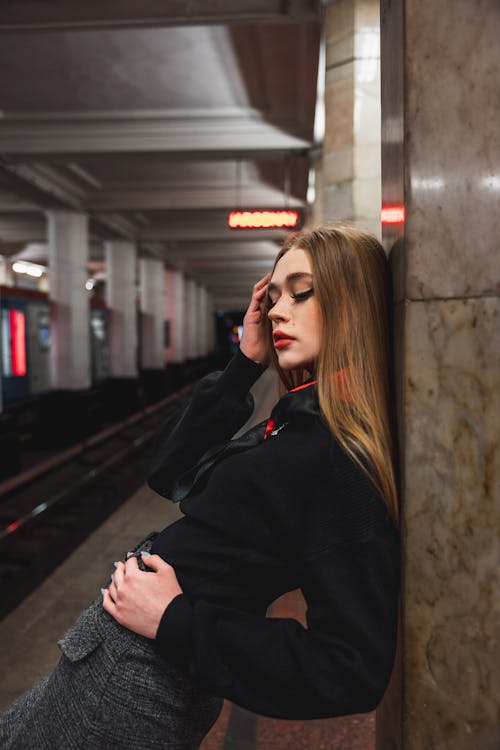 Woman with Brown Hair Leaning on Wall