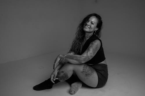 Smiling Woman with Tattoos Sitting