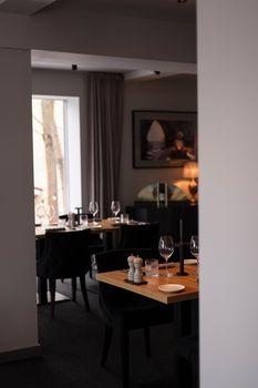 Cozy and stylish restaurant interior featuring elegant decor and sleek wooden tables.
