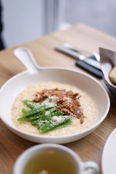 A delightful dish of creamy risotto topped with fresh snap peas and Parmesan cheese, perfect for a gourmet meal.