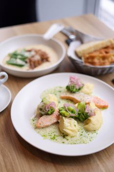 Elegant serving of salmon with broccoli, potatoes, and sauce for a gourmet meal.