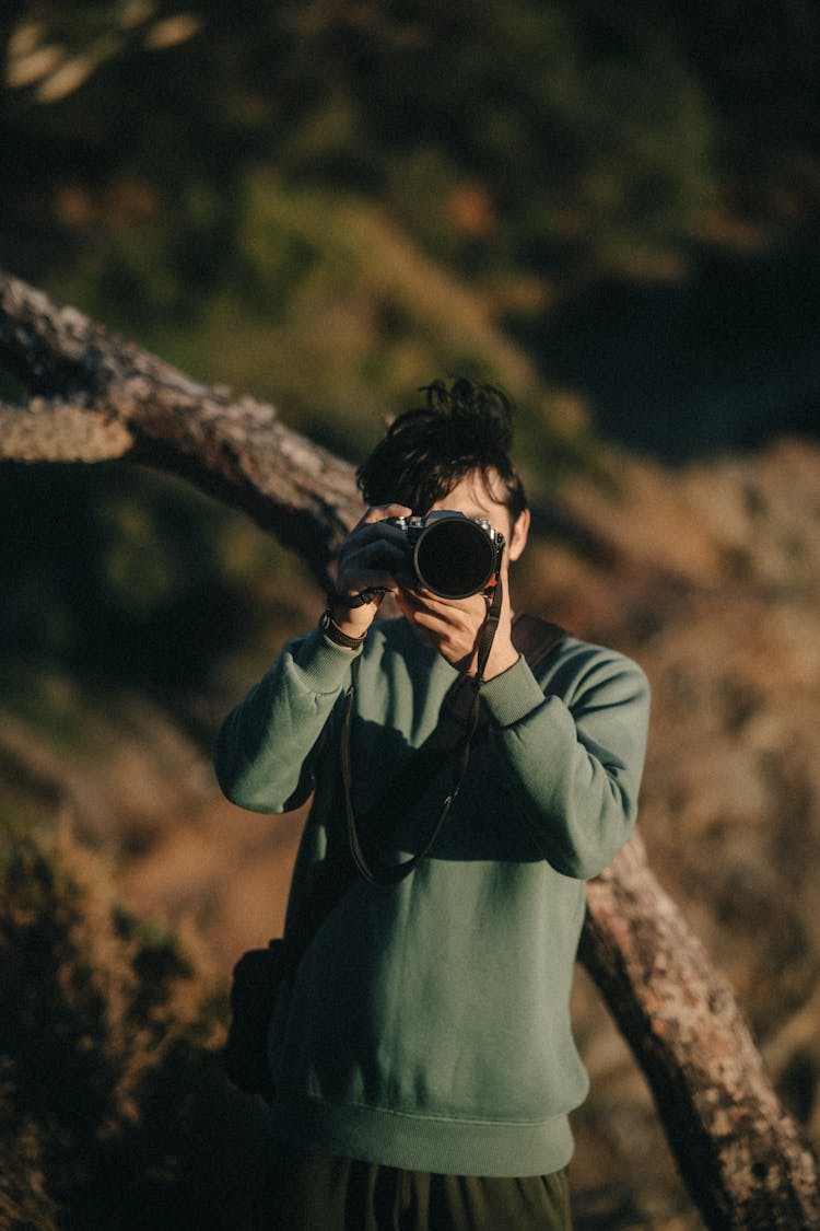 Person Standing With Camera And Taking Pictures