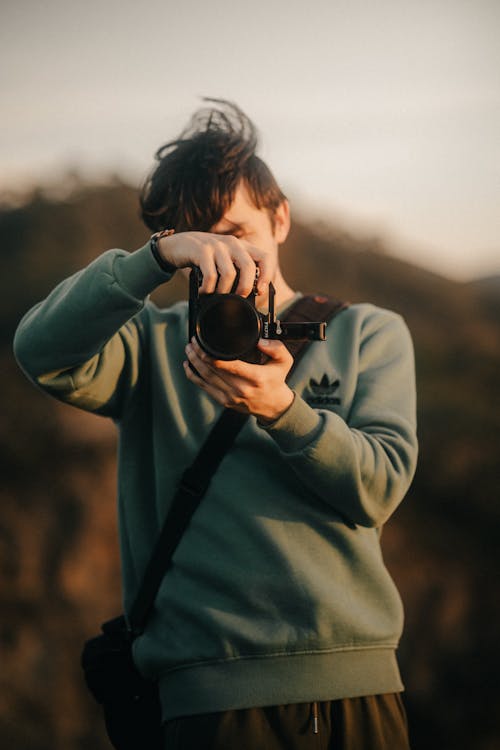 Free Young Man Taking Photos at Sunset Stock Photo