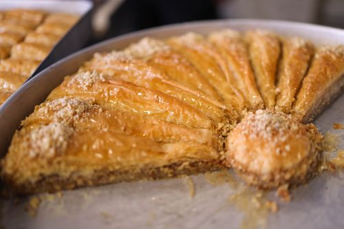 Free Close-up view of freshly made golden baklava, a sweet dessert with filo pastry and nuts. Stock Photo