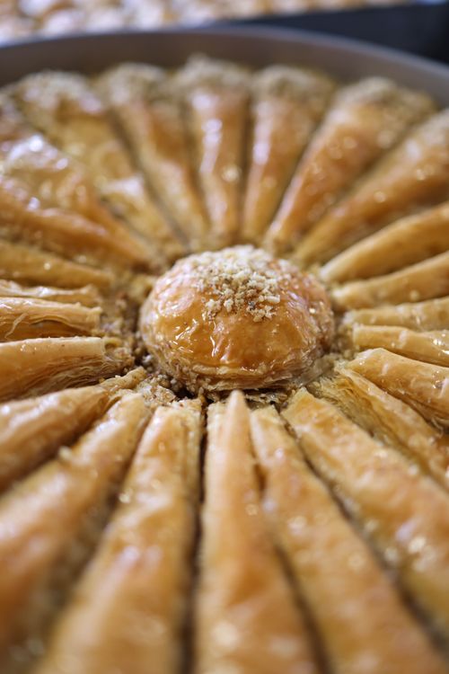 Free Close-up of freshly baked baklava with golden filo pastry and nut topping. Stock Photo