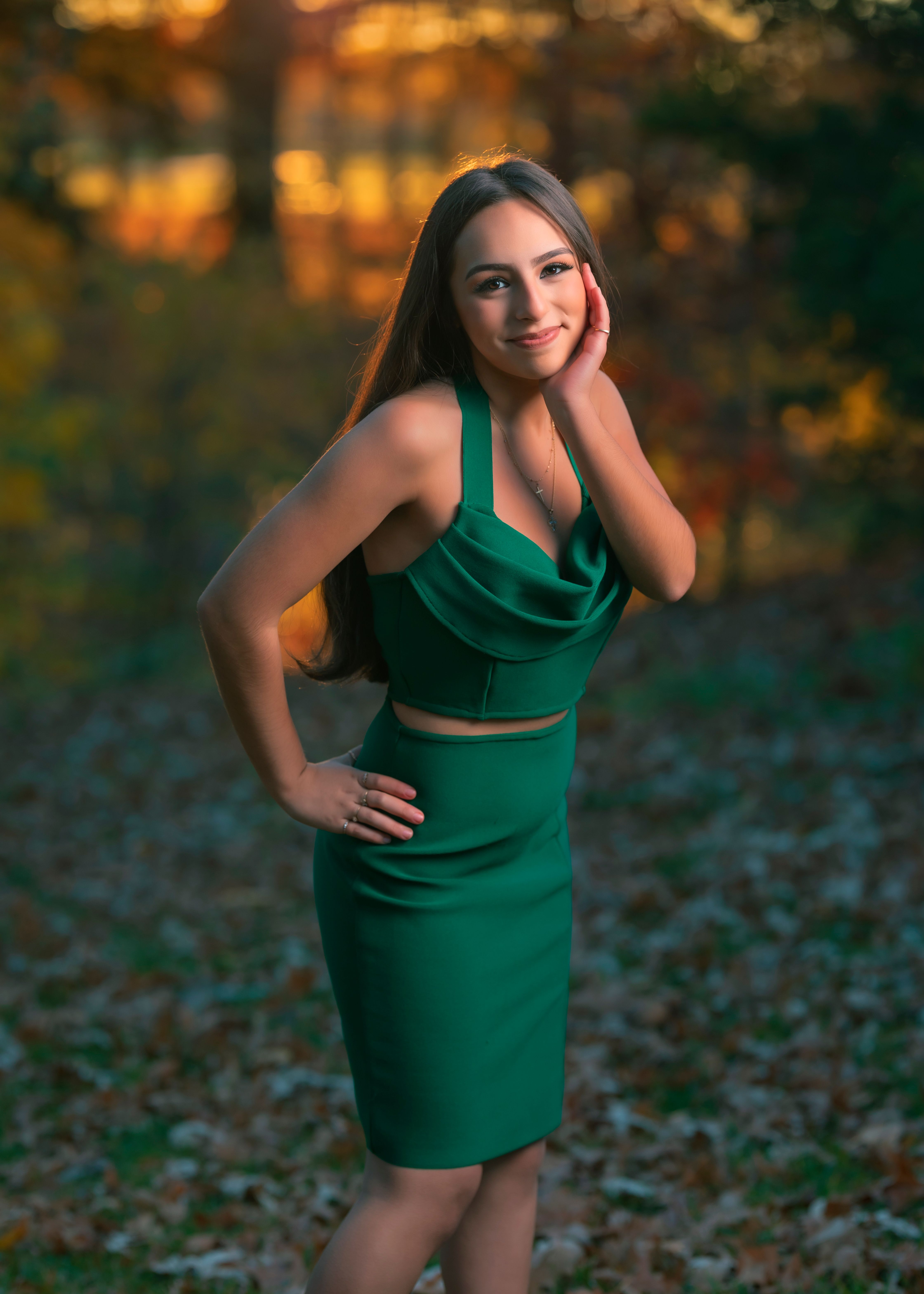 Young Woman in a Green Dress Standing in a Forest · Free Stock Photo
