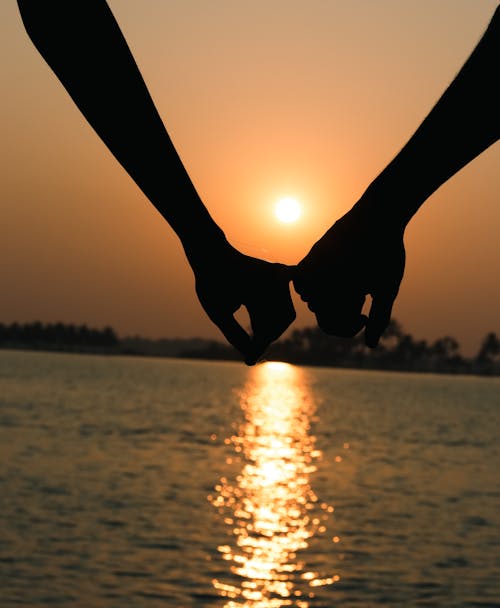 Couple Holding Hands at Sunset 
