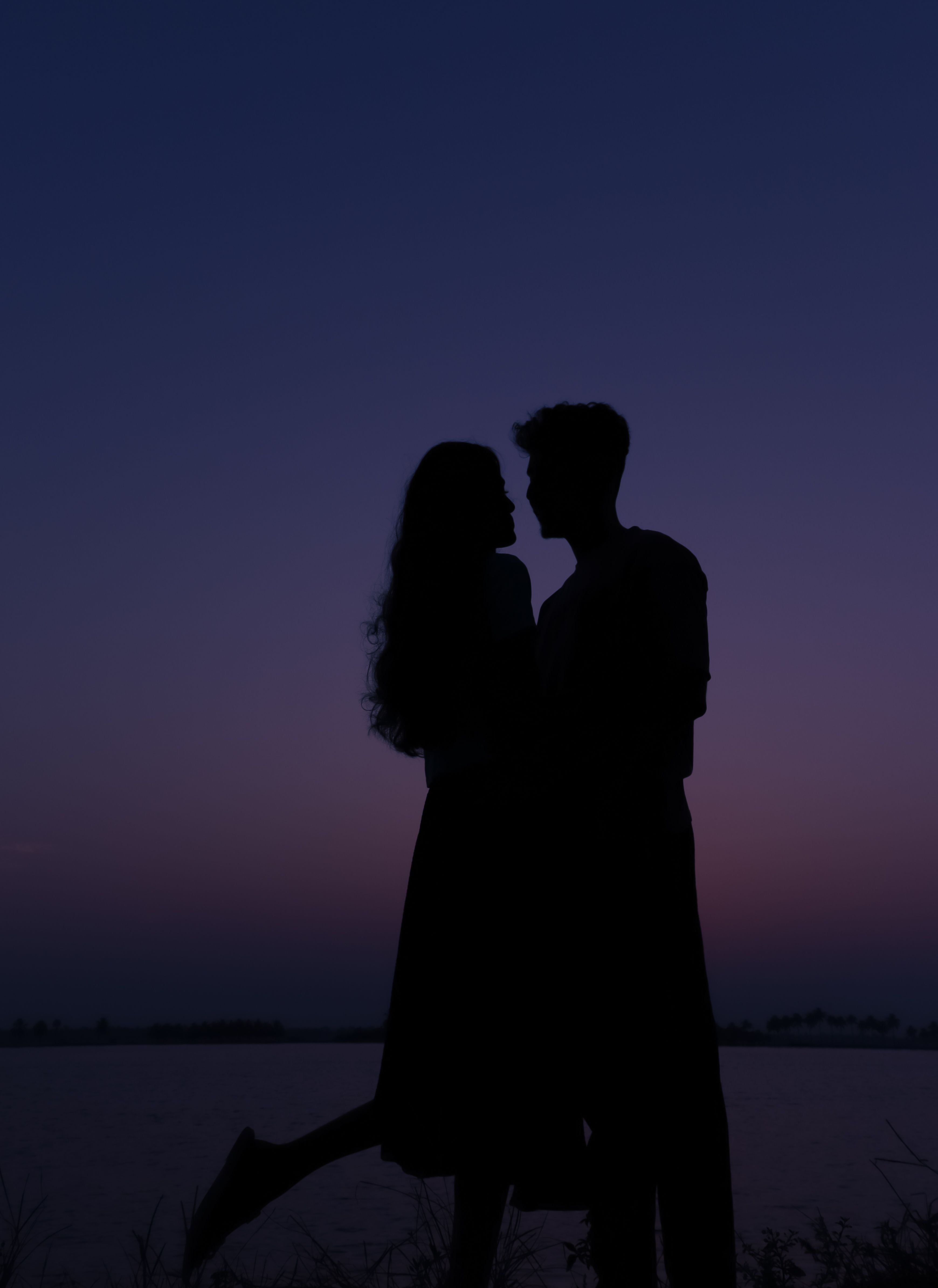 Silhouette of a Couple Embracing by a Body of Water at Dusk · Free ...