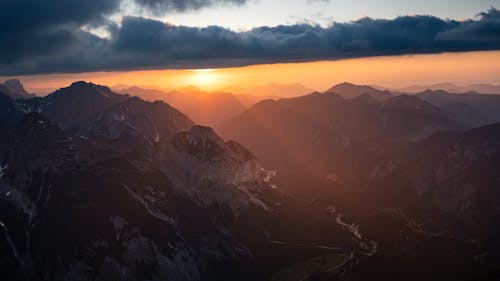 Cloud over Rocky Mountains Peaks and Valley at Sunset