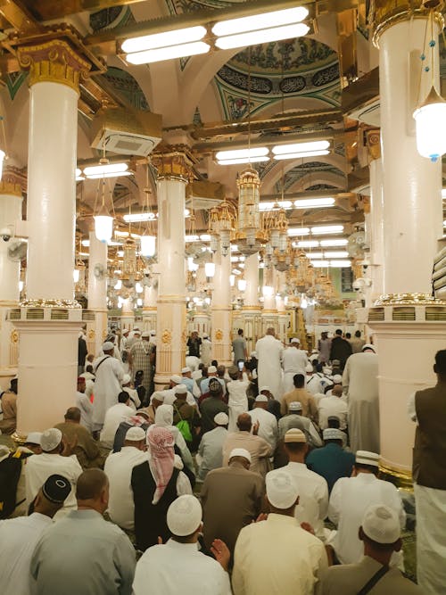 A large crowd of people inside a mosque