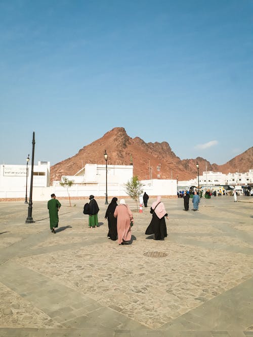 Muslims Walking to Worship in Mountains Landscape