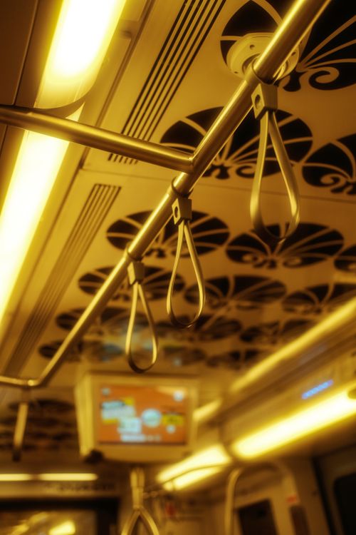 Free A detailed view of a subway train interior showing handles, lighting, and design elements. Stock Photo