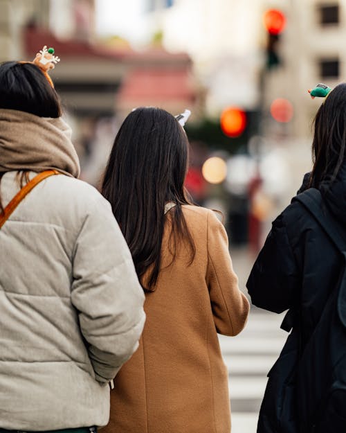 Three women are walking down the street