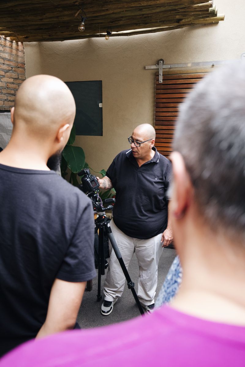 Group of adults engaging in camera techniques workshop indoors.