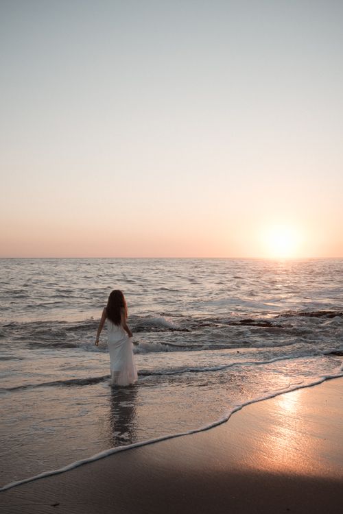 Woman Walking on Sea Shore at Sunset · Free Stock Photo