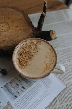 A beautifully crafted cappuccino with nut topping, perfect for cozy reading moments.