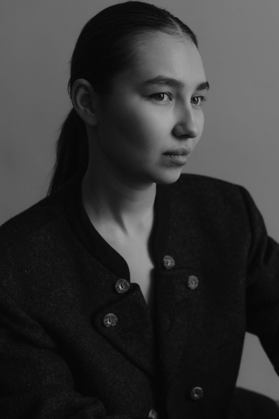 Black and white studio portrait wearing a wool jacket