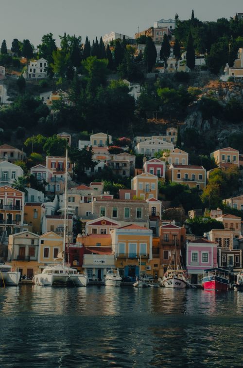 Free Charming coastal village of Symi, Greece with colorful houses and docked boats. Stock Photo