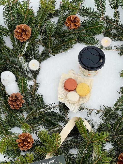 Macarons with Coffee Surrounded by Christmas Decoration